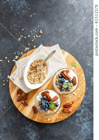 Blueberry parfait with ricotta cheese, granola and Blueberry parfait with ricotta cheese, granola and 61311578