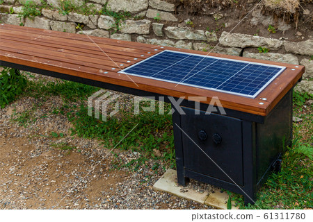 A wooden bench with a solar panel for charging a 61311780