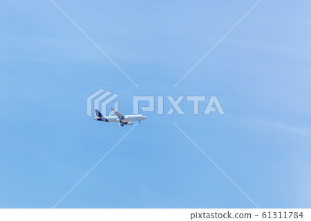 The plane is flying in the blue sky 61311784