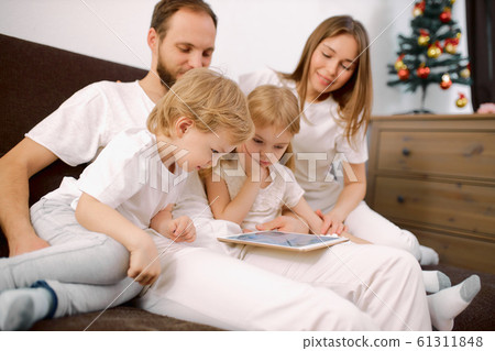 beautiful caucasian family watching video on tablet at home 61311848