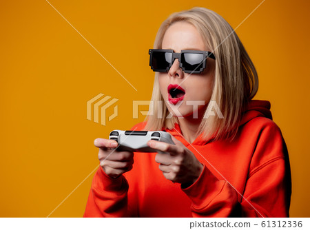 girl in sunglasses keen plays with a joystick 61312336