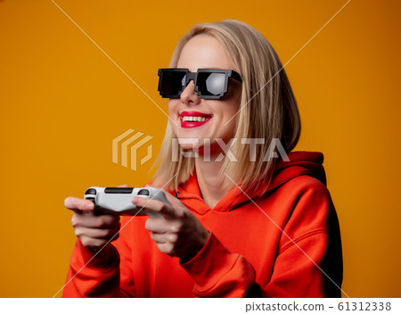 girl in sunglasses keen plays with a joystick girl in sunglasses keen plays with a joystick 61312338