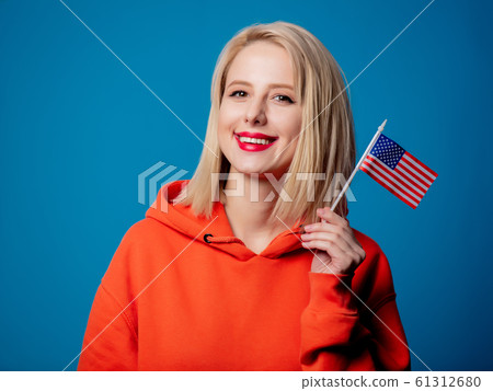 girl holds United States of America flag on blue background girl holds United States of America flag on blue background 61312680