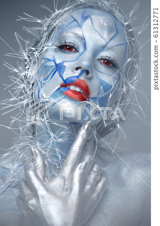 Beautiful girl in an unusual winter look with red lips. Creative make- up. Art look. 61312771