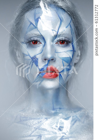 Beautiful girl in an unusual winter look with red lips. Creative make- up. Art look. Beautiful girl in an unusual winter look with red lips. Creative make- up. Art look. 61312772
