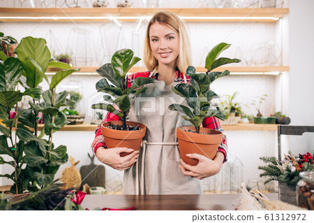 Gardening. Young caucasian florist woman working at garden Gardening. Young caucasian florist woman working at garden 61312972