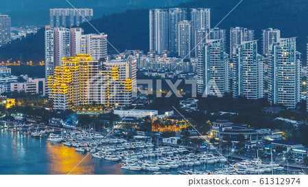 Haikou city with high modern buildings on Nandu River bank 61312974