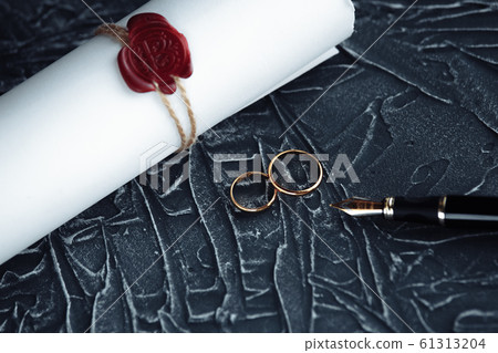 Two broken golden wedding rings divorce decree document. Divorce and separation concept Two broken golden wedding rings divorce decree document. Divorce and separation concept 61313204