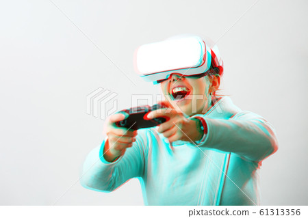 Woman with virtual reality headset is playing game. Image with glitch effect. 61313356