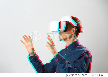 Man with virtual reality headset is playing game. Image with glitch effect. 61313370