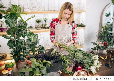 flowers composition by beautiful florist woman 61313532