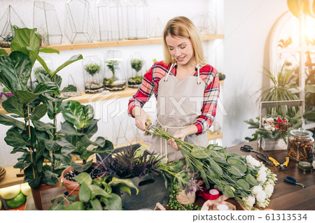 young good-looking small business owner of a retail flower shop and garden center young good-looking small business owner of a retail flower shop and garden center 61313534