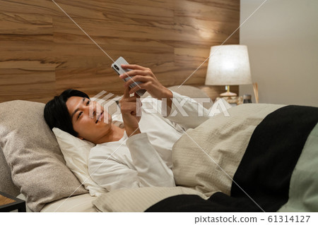 Young man sleeping bedroom lifestyle image 61314127
