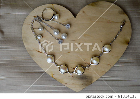 A wooden heart for Valentine's Day with silver A wooden heart for Valentine's Day with silver 61314135