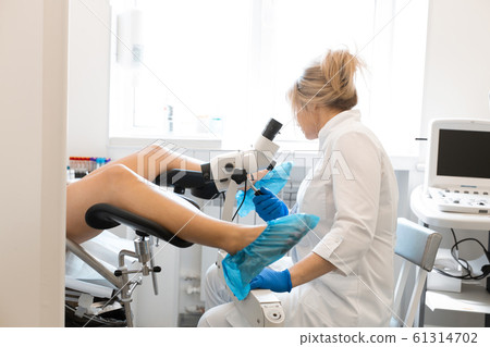 A blond woman doctor, gynecologist examines a 61314702