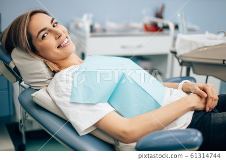pleased patient after teeth treatment pleased patient after teeth treatment 61314744