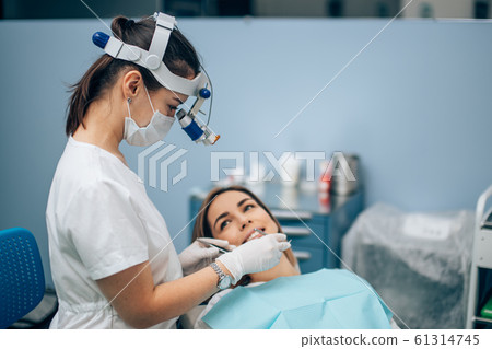 Dentist looking for spoiled teeth Dentist looking for spoiled teeth 61314745