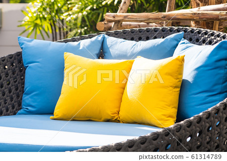 Outdoor patio in the garden with sofa chair and pillow decoration Outdoor patio in the garden with sofa chair and pillow decoration 61314789