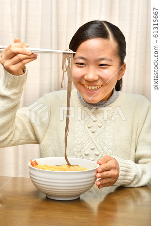 Girl eating New Year's Eve Soba (New Year's Eve) 61315667
