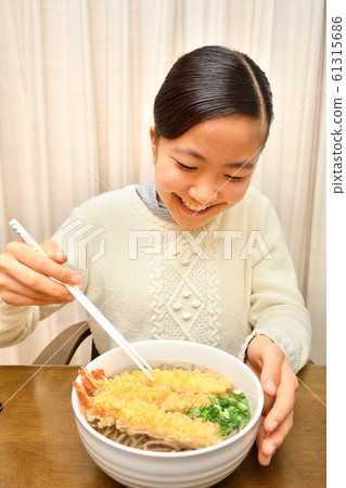 Girl eating New Year's Eve Soba (New Year's Eve) Girl eating New Year's Eve Soba (New Year's Eve) 61315686
