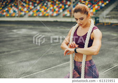 The girl at the stadium is playing sports The girl at the stadium is playing sports 61315951