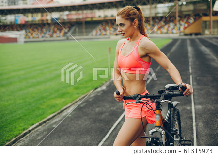 The girl at the stadium is playing sports The girl at the stadium is playing sports 61315973