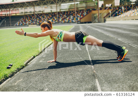 The girl at the stadium is playing sports The girl at the stadium is playing sports 61316124