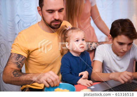 awesome caucasian family with laptop in kitchen at home 61316518