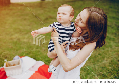 Mom and son relax in the park. Mom and son relax in the park. 61316880