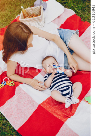 Mom and son relax in the park. Mom and son relax in the park. 61316942
