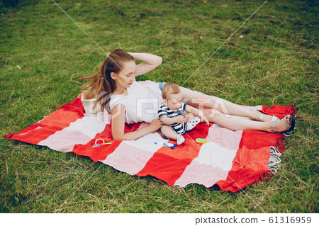 Mom and son relax in the park. 61316959