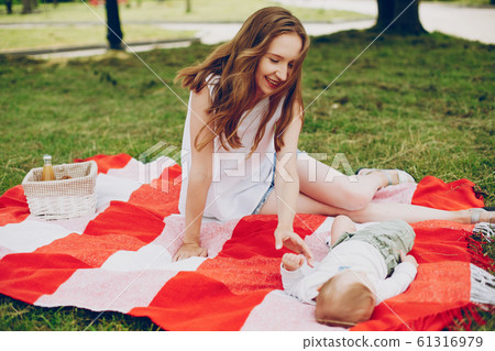 Mom and son relax in the park. Mom and son relax in the park. 61316979