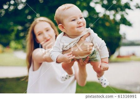 Mom and son relax in the park. 61316991