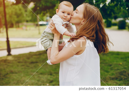 Mom and son relax in the park. Mom and son relax in the park. 61317054
