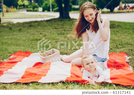 Mom and son relax in the park. Mom and son relax in the park. 61317141