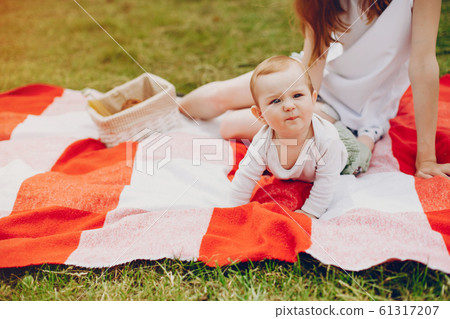 Mom and son relax in the park. Mom and son relax in the park. 61317207