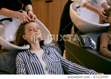 young caucasian girls came in beauty saloon for changing colour of hair 61318397
