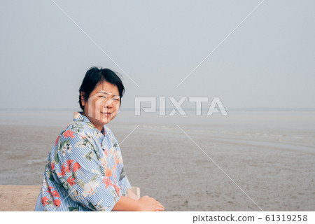 Woman happy travel freedom carefree relax at sea 61319258