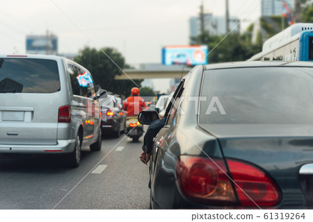 Cars on busy road in the city with traffic jam Cars on busy road in the city with traffic jam 61319264