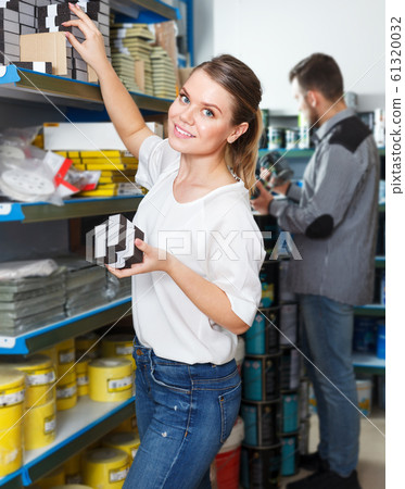 Woman choosing household tools 61320032