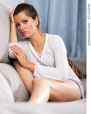 Frustrated woman on sofa 61320249