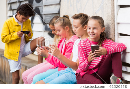 Children are playing on smartphone Children are playing on smartphone 61320358