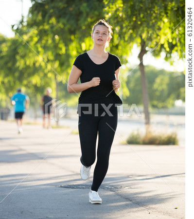 Girl jogging during outdoor workout 61320464