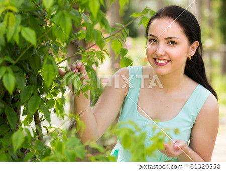 spring positive smiling young female portrait in garden 61320558