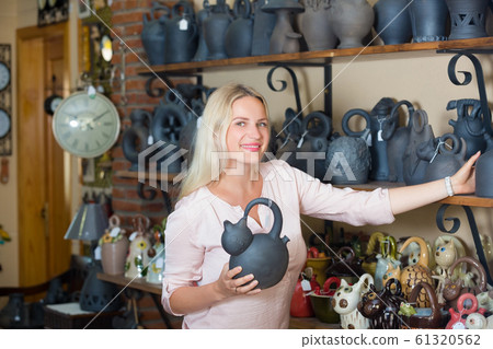 Woman choosing dish-ware 61320562