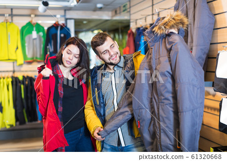 Couple examining windcheaters in store 61320668