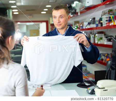 Male administrator offers white t-shirt for drawing picture 61320770