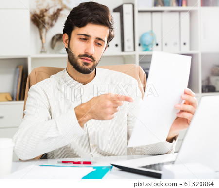 Office worker holding paper with contract Office worker holding paper with contract 61320884