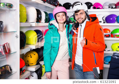 Man and woman standing with purchased ski equipment in shop Man and woman standing with purchased ski equipment in shop 61321091