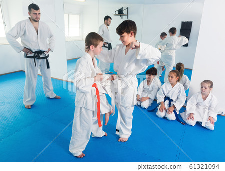 Young children trying in sparring to use new moves 61321094